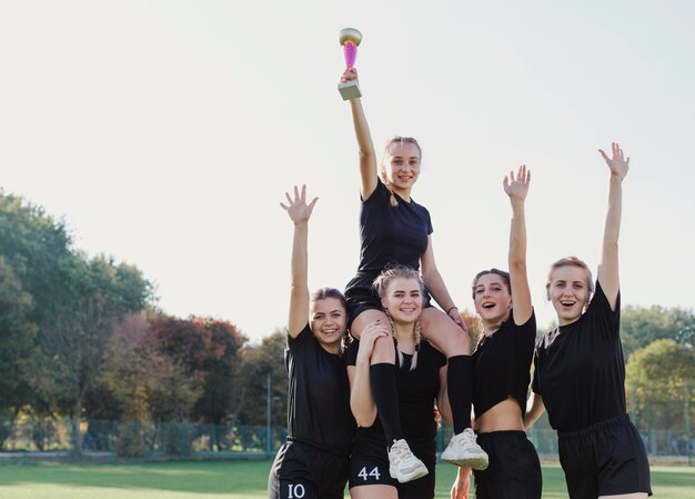 Sportive girls winning a trophy