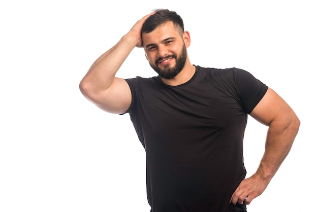 Sportive man in black shirt feeling strong