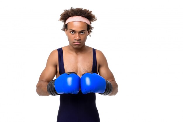 Sportive man in boxing gloves posing