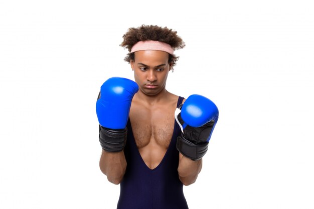 Sportive man in boxing gloves posing