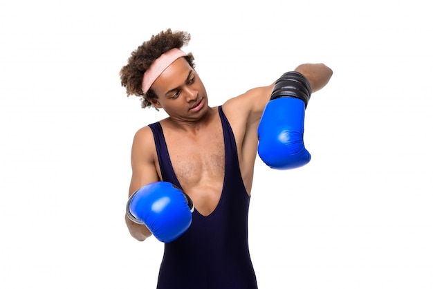 Sportive man in boxing gloves posing