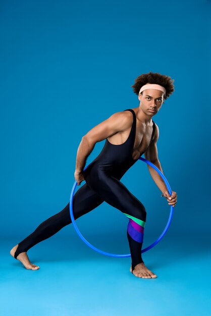 Sportive man posing with hoop