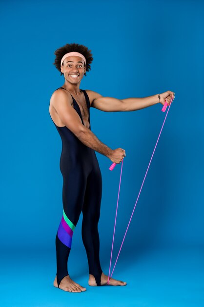 Sportive man posing with skipping rope