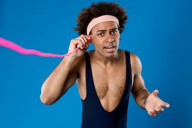 Sportive man posing with skipping rope