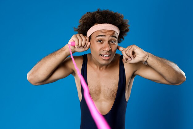 Sportive man posing with skipping rope
