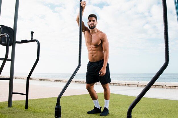 Sportive man standing after set of exercises