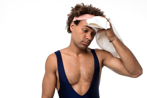 Sportive man wiping with towel