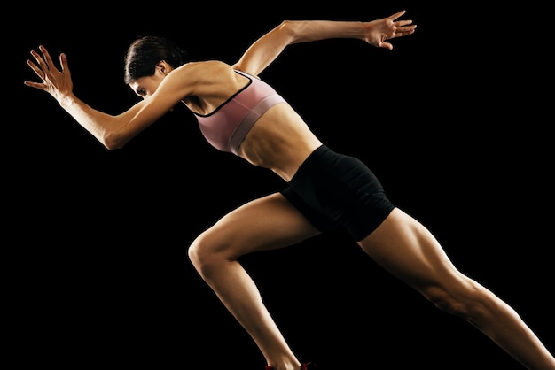 Sportive woman professional running athlete in uniform posing isolated over white studio background