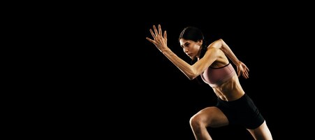 Sportive woman professional running athlete in uniform posing isolated over white studio background