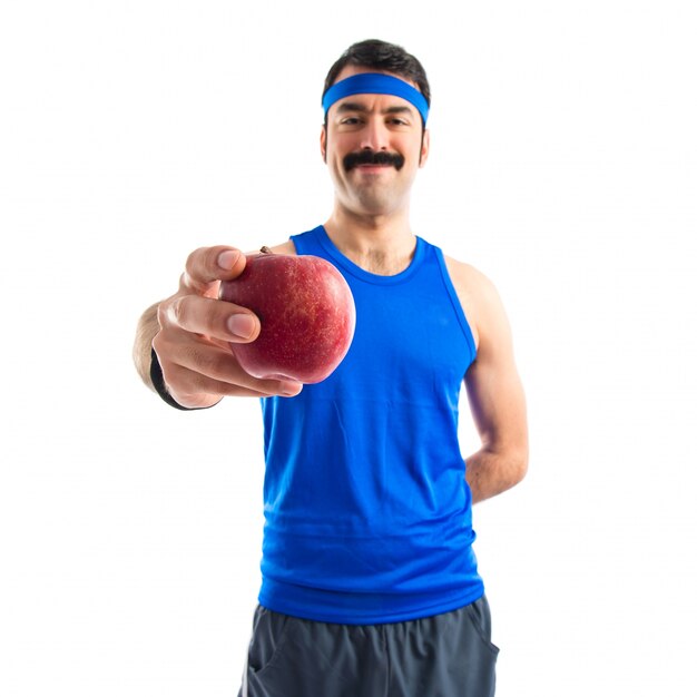 Sportman holding an apple