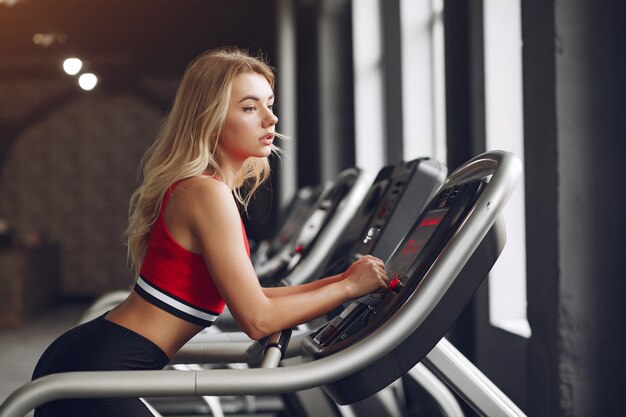 Sports blonde in a sportswear training in a gym