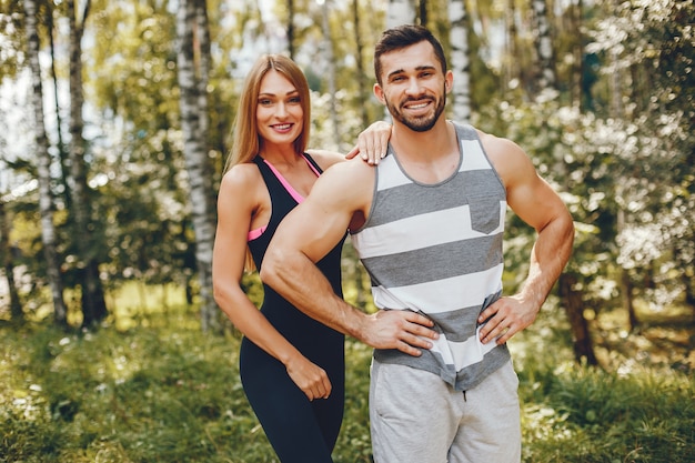 Sports couple in a morning summer park