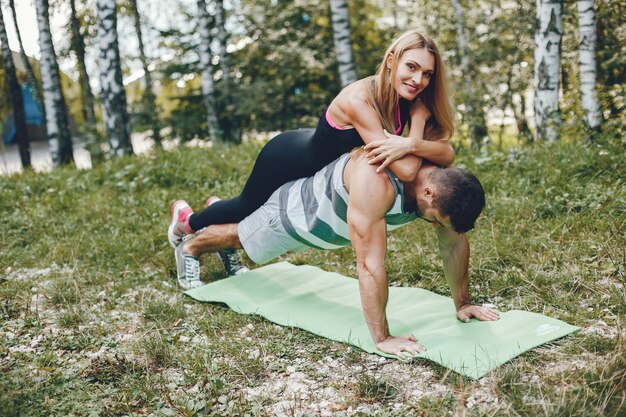 Sports couple in a morning summer park