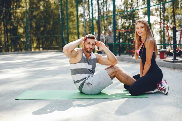 Sports couple in a morning summer park