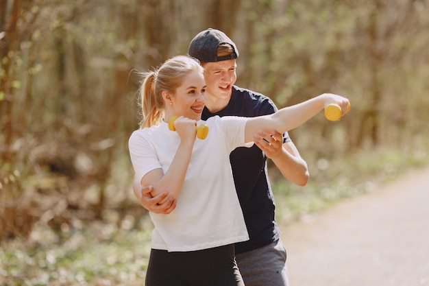Sports couple training in a summer forest