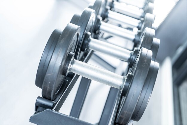 Sports dumbbells in modern sports club.