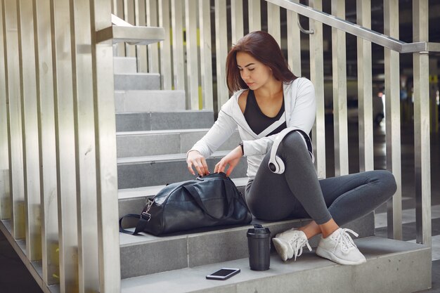 Sports girl in a sports clothes in a city