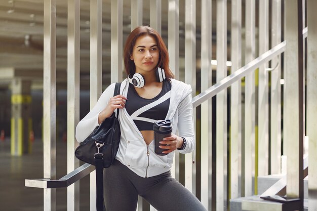 Sports girl in a sports clothes in a city