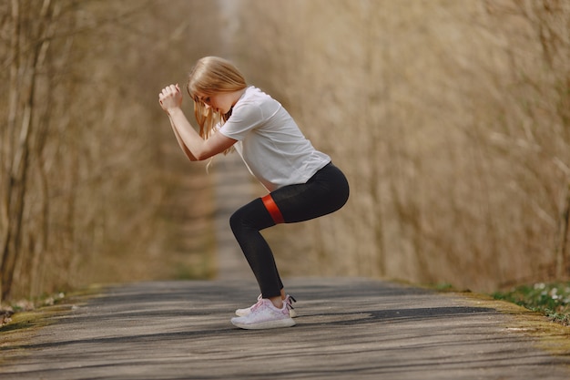 Free photo sports girl training in a summer forest