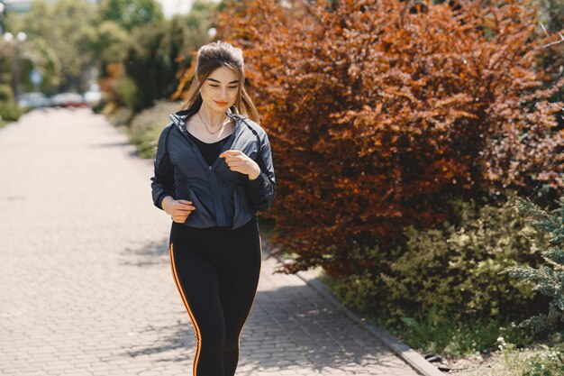 Sports girl training in a summer forest