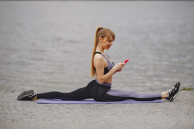 Sports girl training in a summer park