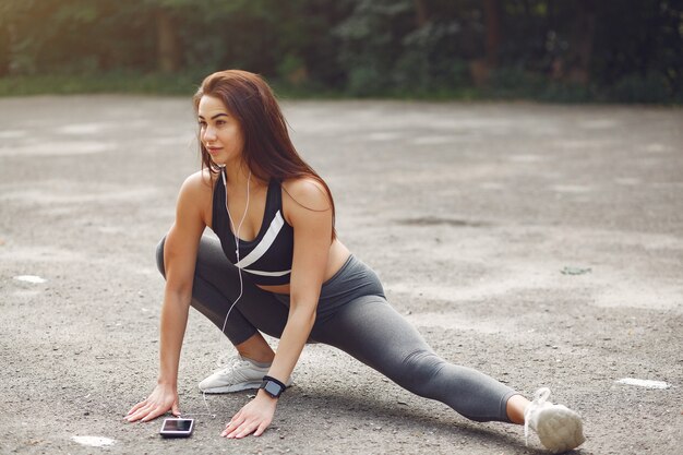 Sports girl training with phone and headphones