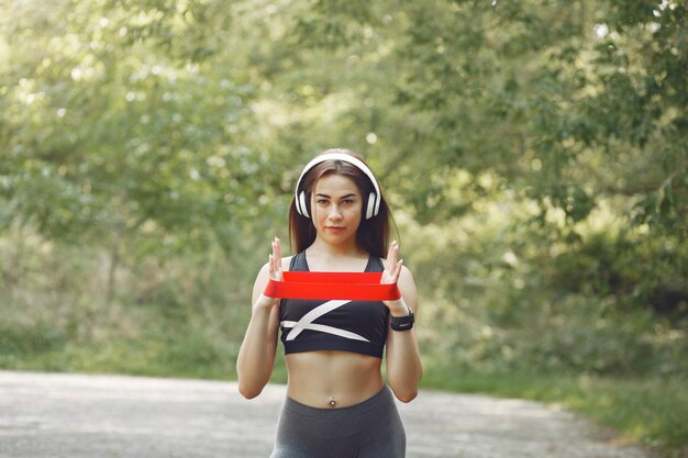 Sports girl training with sports elastic bands