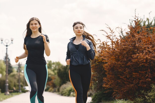 Sports girls training in a summer forest