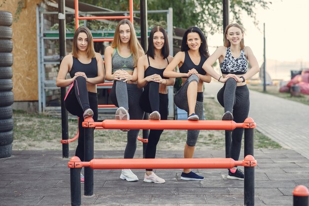 Sports girls training in a summer park