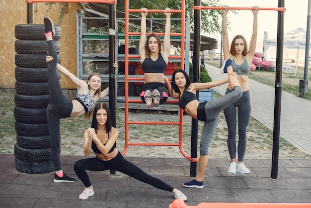 Sports girls training in a summer park
