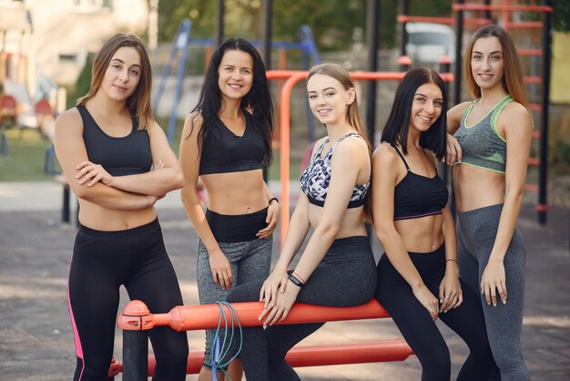 Sports girls training in a summer park