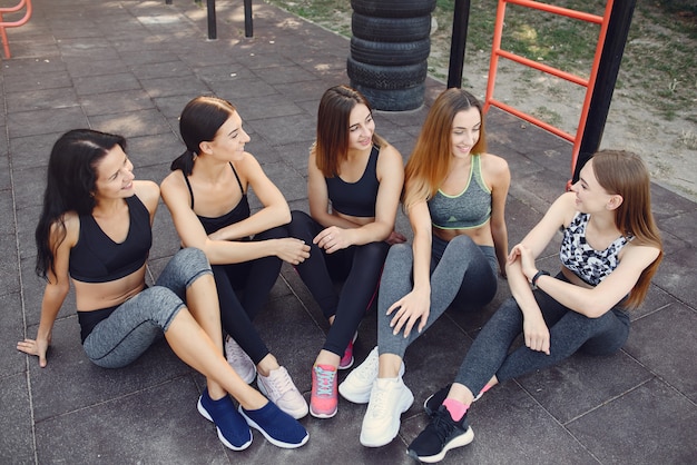 Sports girls training in a summer park