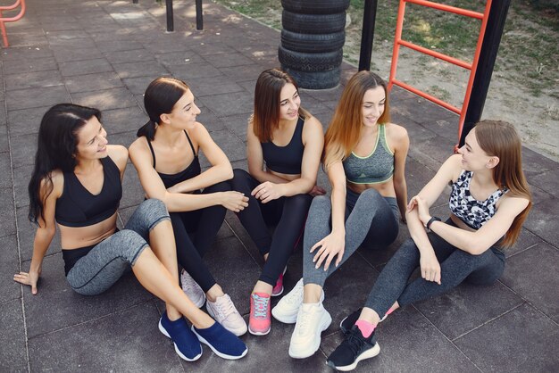 Sports girls training in a summer park