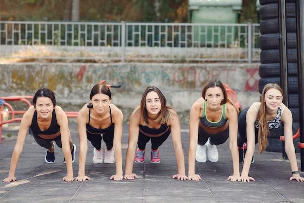 Sports girls training in a summer park