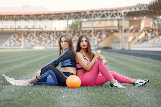 Free photo sports girls in a uniform training at the stadium