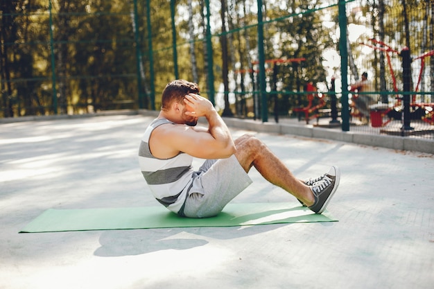 Sports man in a morning summer park 