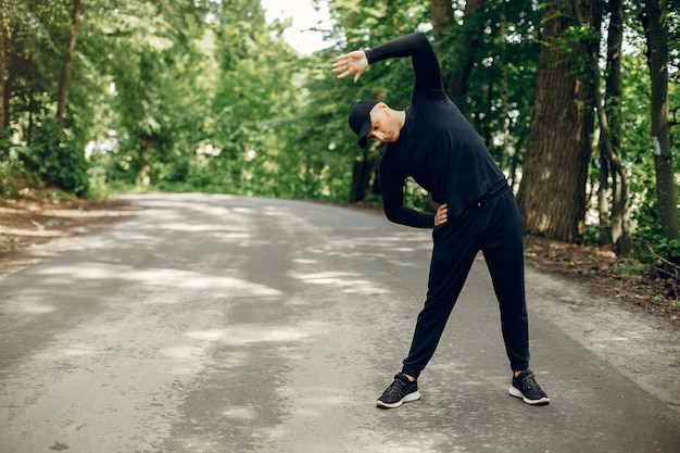 Sports man in a morning summer park