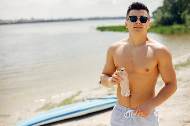 Free photo sports man training on a beach