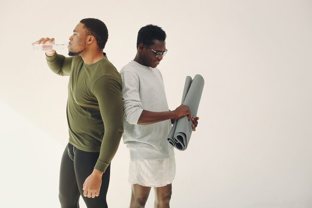 Sports men standing on a white wall