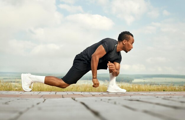 Sportsman doing stretching exercises outdoors