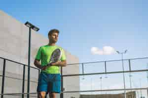 Free photo sportsman playing padel game