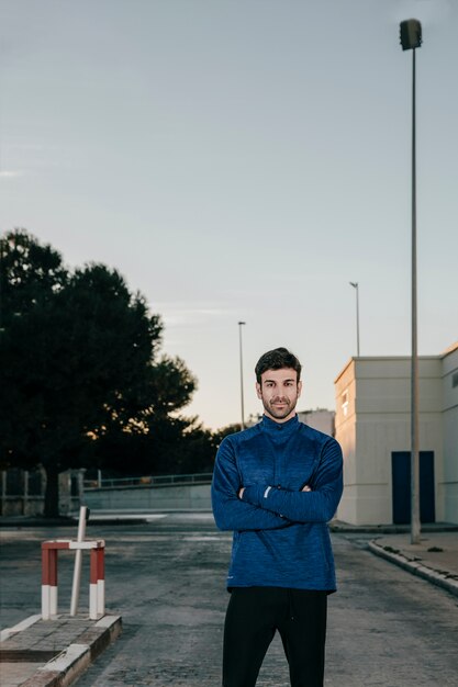 Sportsman posing at camera on street