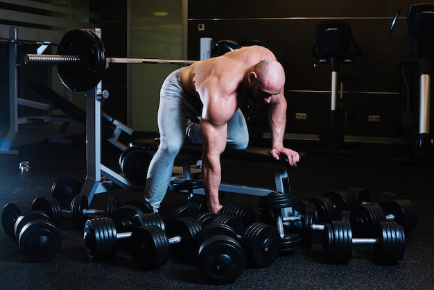 Sportsman preparing to lift dumbbell