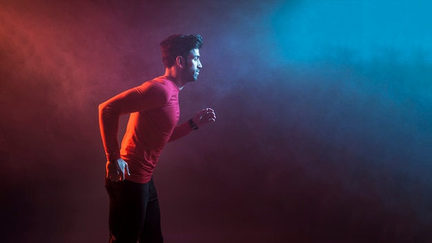 Sportsman running in dark smoke