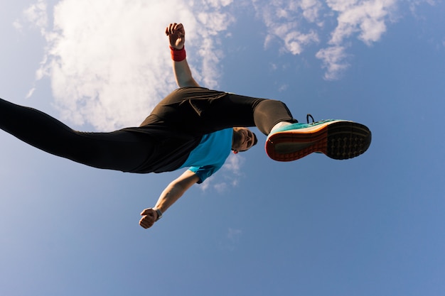 Sportsman runs and jump into the sky