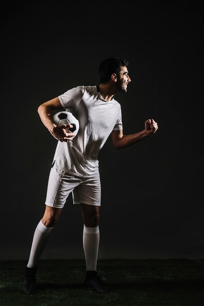 Sportsman with ball celebrating victory