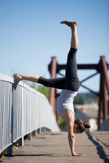 Sportswoman doing balance exercises outdoors