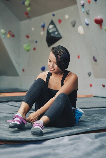 Sportswoman preparing for climbing wall