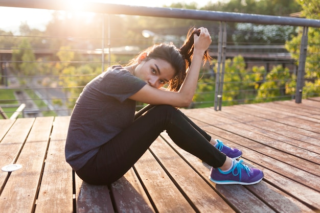 Free photo sportswoman resting and playing with her hair