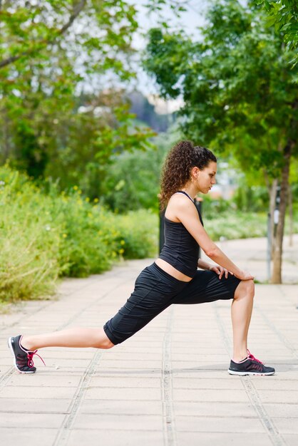 Sportswoman stretching and preparing to run